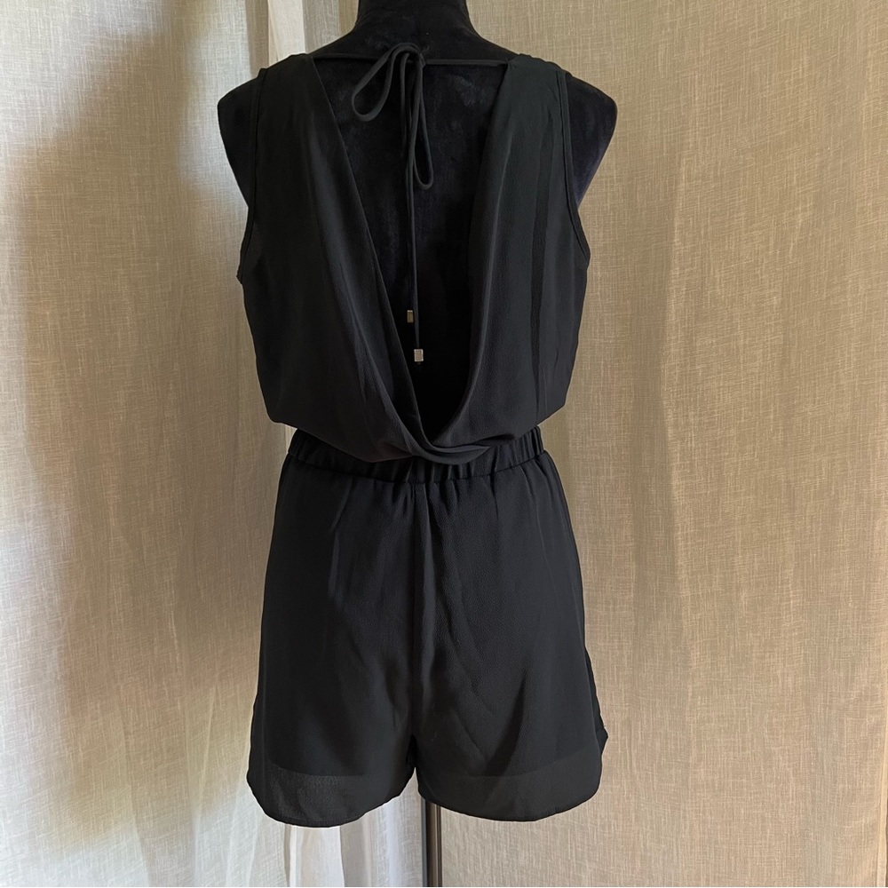 Black Romper with Ties in the Back and a Scoop Low Back that Ties at the Waist.